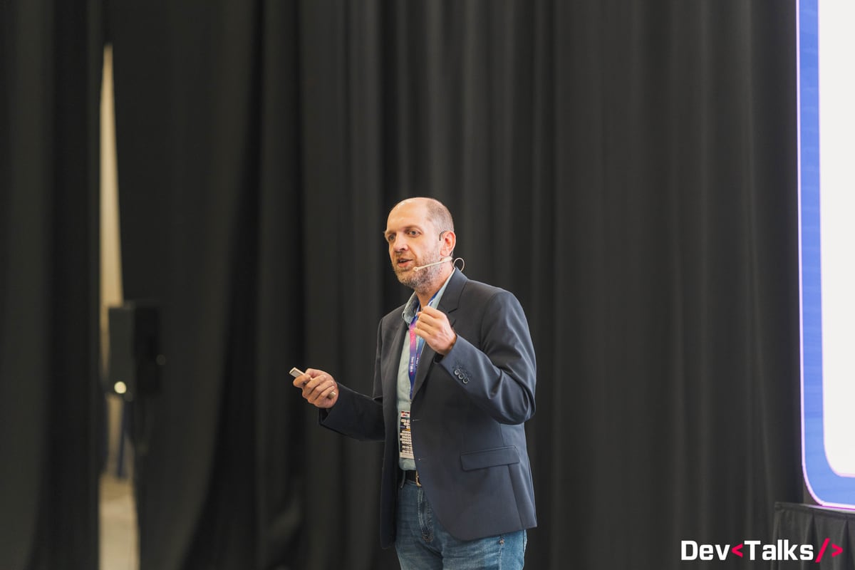 Dan Patrascu-Baba speaking on stage at DevTalks