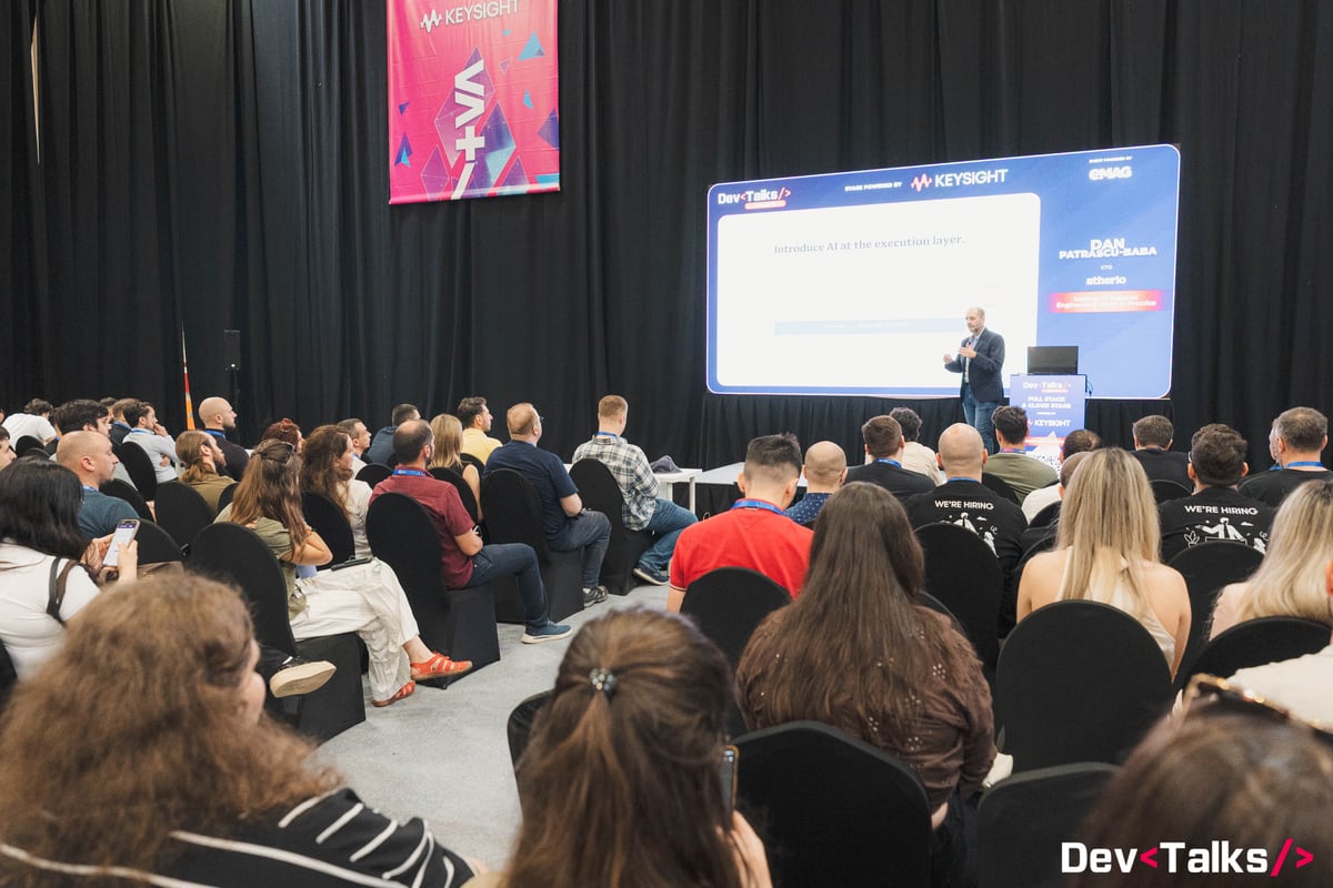 Dan Patrascu-Baba presenting to a conference audience at DevTalks